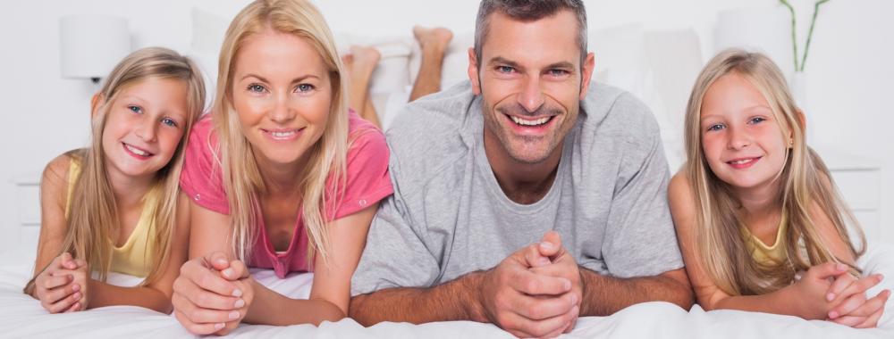 Parents lying in bed with their children.jpg